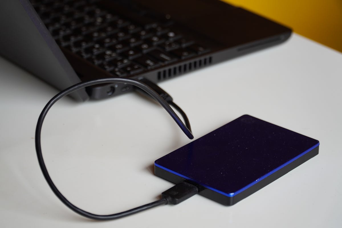 External hard drive connected to a laptop for backup