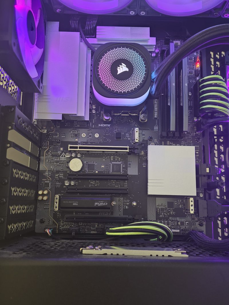Motherboard with the graphics card removed, top M.2 slot empty where the ADATA drive was fitted and the Crucial T500 still in the lower slot